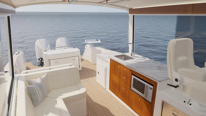 Slide: The Image of Luxurious 2026 MJM 38R yacht interior with modern kitchen and seating, overlooking serene ocean. - 8