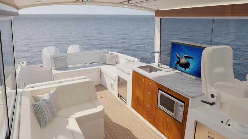 Slide: The Image of Luxurious 2026 MJM 38R yacht interior with seating, kitchenette, and ocean view. - 9