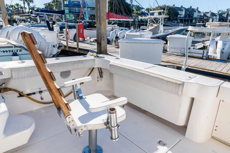 Slide: The Image of 2004 Luhrs 36 Convertible boat deck with fishing chair at marina. - 14