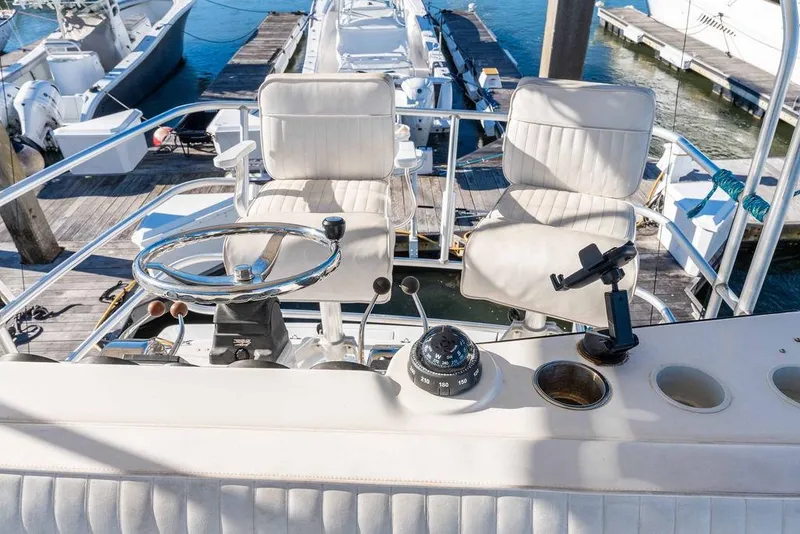 Slide: The Image of Helm of 2004 Luhrs 36 Convertible yacht with dual seats and steering wheel. - 20