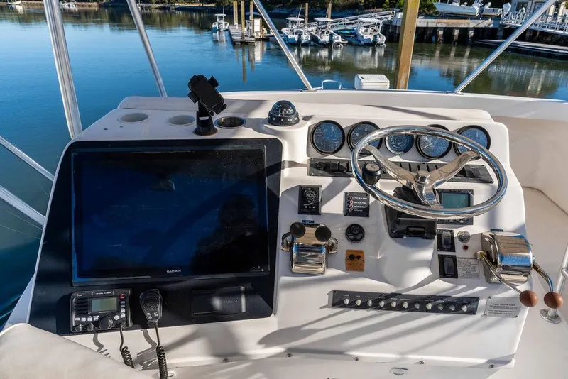 Slide: The Image of Helm of 2004 Luhrs 36 Convertible boat with navigation instruments and steering wheel. - 21