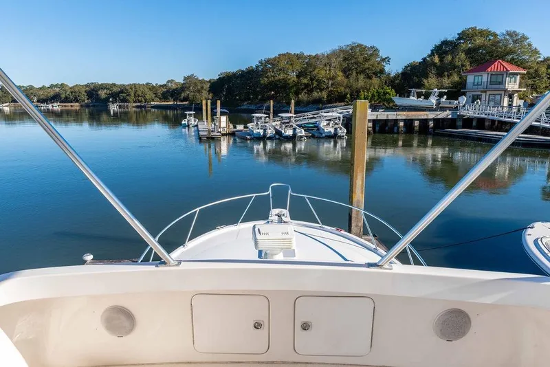 Slide: The Image of Bow view of 2004 Luhrs 36 Convertible yacht at a serene marina. - 22