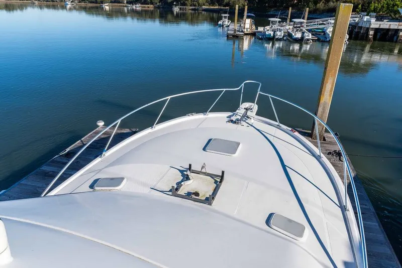 Slide: The Image of 2004 Luhrs 36 Convertible yacht docked at a serene marina. - 24