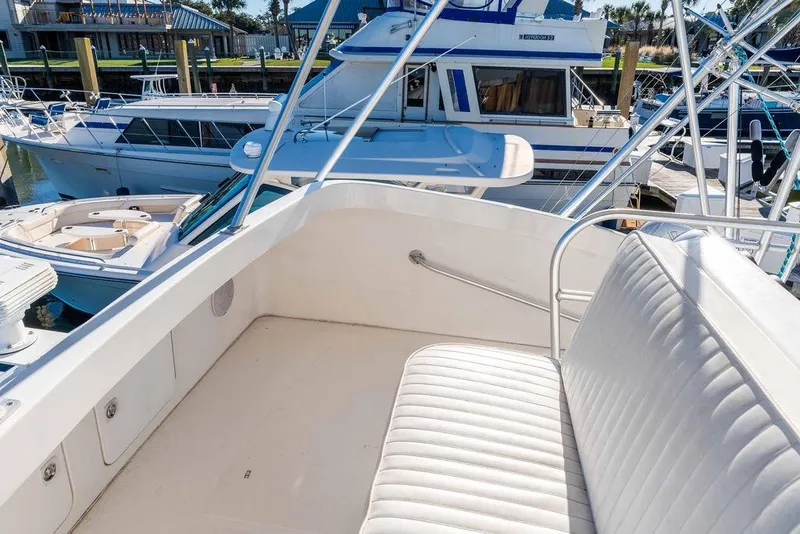 Slide: The Image of 2004 Luhrs 36 Convertible yacht interior with white seating, docked at marina. - 25