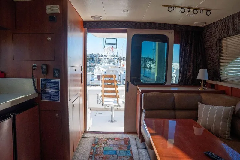 Slide: The Image of Interior of 2004 Luhrs 36 Convertible yacht with cozy seating and marina view. - 26