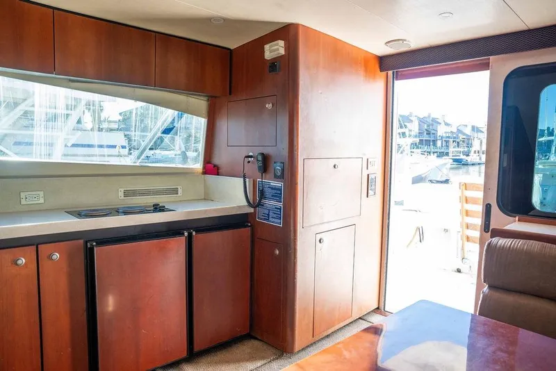 Slide: The Image of Interior of 2004 Luhrs 36 Convertible yacht with kitchenette and marina view. - 28