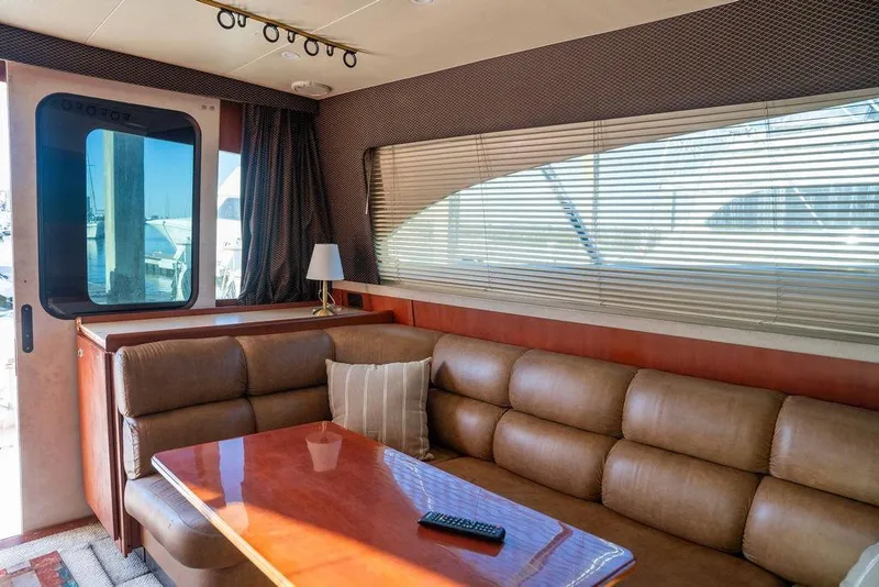Slide: The Image of Interior of 2004 Luhrs 36 Convertible yacht with leather seating and wooden table. - 35