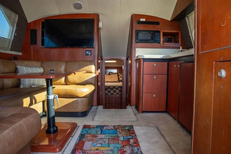 Slide: The Image of Interior of 2004 Luhrs 36 Convertible yacht with cozy seating and modern amenities. - 38