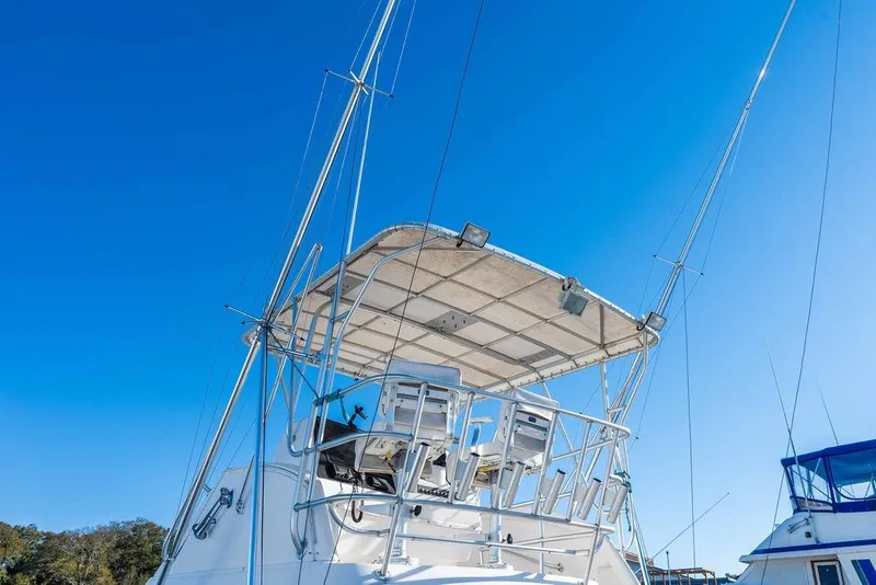 Slide: The Image of 2004 Luhrs 36 Convertible boat with fishing tower against clear blue sky. - 4