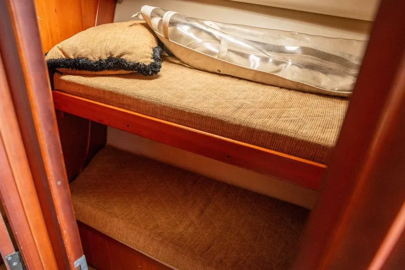 Slide: The Image of 2004 Luhrs 36 Convertible cabin with cozy bunk beds and wooden interior. - 40