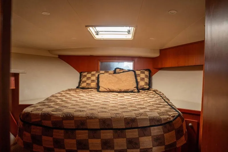 Slide: The Image of 2004 Luhrs 36 Convertible cabin with cozy bed and elegant wood finish. - 43