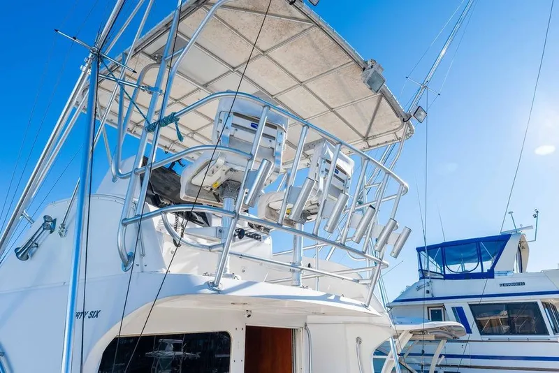 Slide: The Image of 2004 Luhrs 36 Convertible boat with flybridge and fishing rod holders. - 5