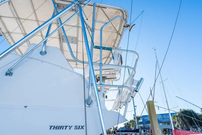 Slide: The Image of 2004 Luhrs 36 Convertible yacht in harbor, blue sky. - 6