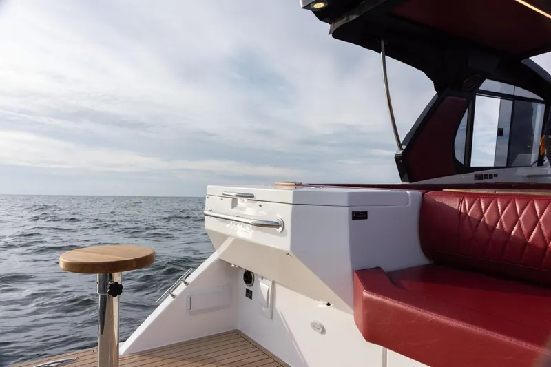 Slide: The Image of Luxury Hanover 387 yacht interior with red seating, ocean view, 2026 model. - 8