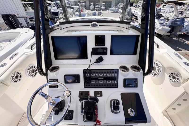 Slide: The Image of Cockpit view of 2020 Tidewater 320 CC Adventure boat with advanced navigation controls. - 10