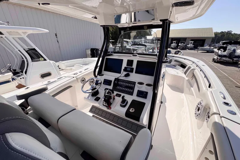Slide: The Image of 2020 Tidewater 320 CC Adventure boat interior with modern helm and navigation equipment. - 11