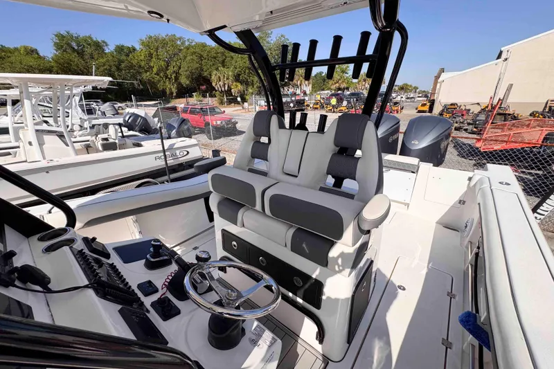 Slide: The Image of 2020 Tidewater 320 CC Adventure boat interior with dual seating and control panel. - 12