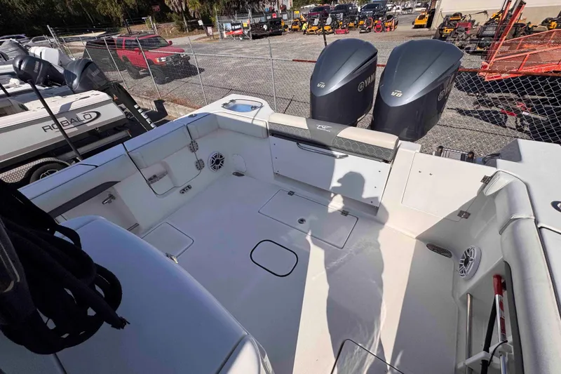 Slide: The Image of 2020 Tidewater 320 CC Adventure boat interior with Yamaha V8 engines, docked outdoors. - 15