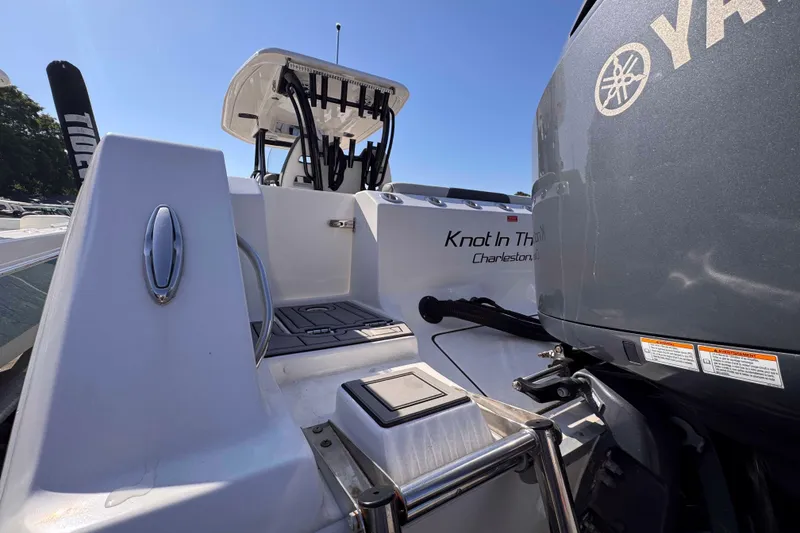 Slide: The Image of 2020 Tidewater 320 CC Adventure boat with Yamaha engine, docked under clear blue sky. - 17