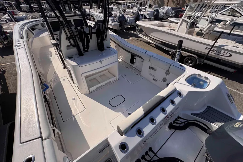 Slide: The Image of 2020 Tidewater 320 CC Adventure boat interior with seating and storage compartments. - 18