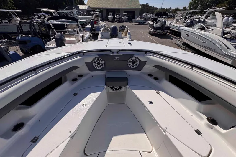Slide: The Image of 2020 Tidewater 320 CC Adventure boat interior at a marina, showcasing seating and speakers. - 21