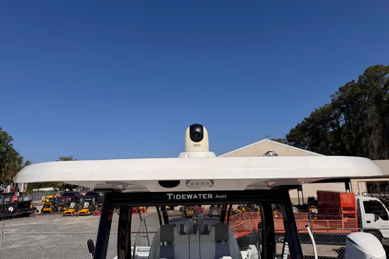 Slide: The Image of 2020 Tidewater 320 CC Adventure boat with radar, clear sky background. - 22