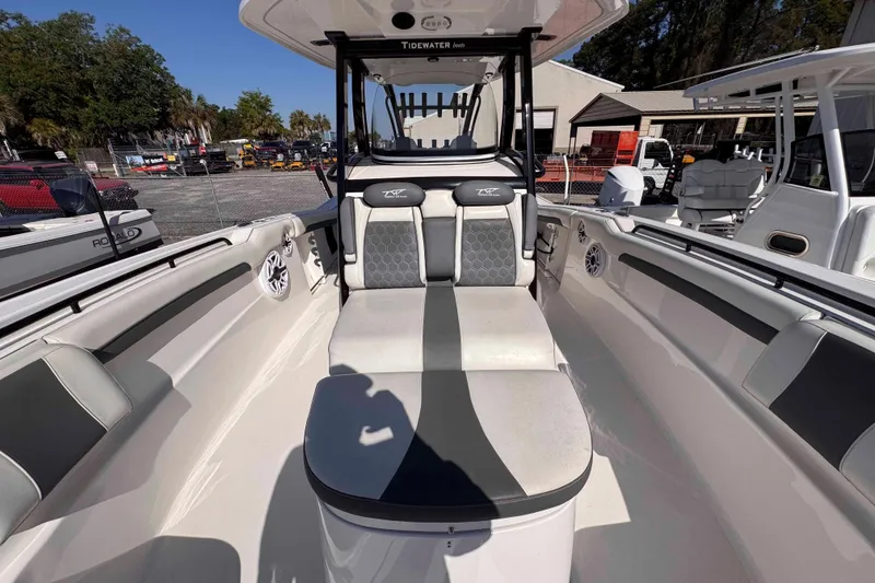 Slide: The Image of 2020 Tidewater 320 CC Adventure boat interior with seating and console. - 23