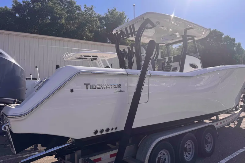 Slide: The Image of 2020 Tidewater 320 CC Adventure boat on trailer, side view in sunlight. - 26