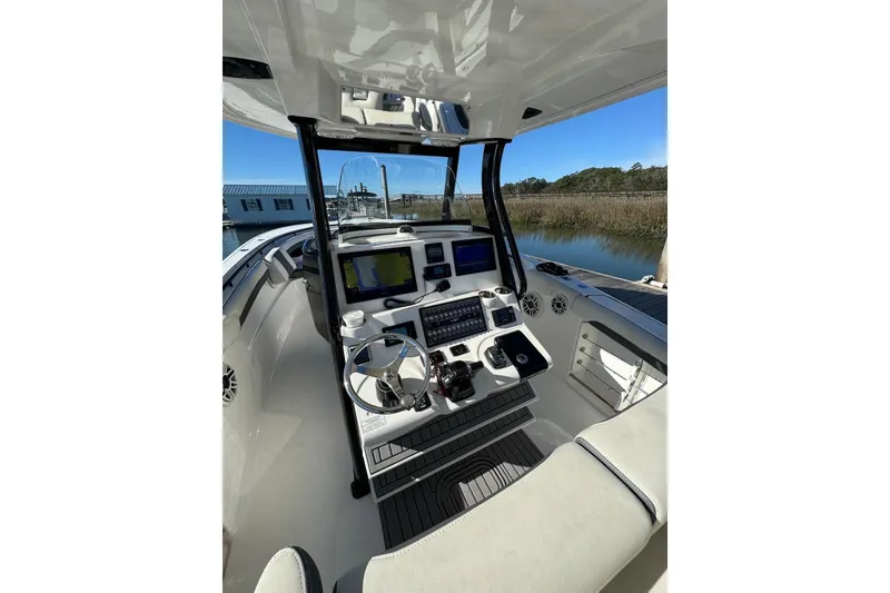 Slide: The Image of 2020 Tidewater 320 CC Adventure boat cockpit with modern navigation equipment. - 4