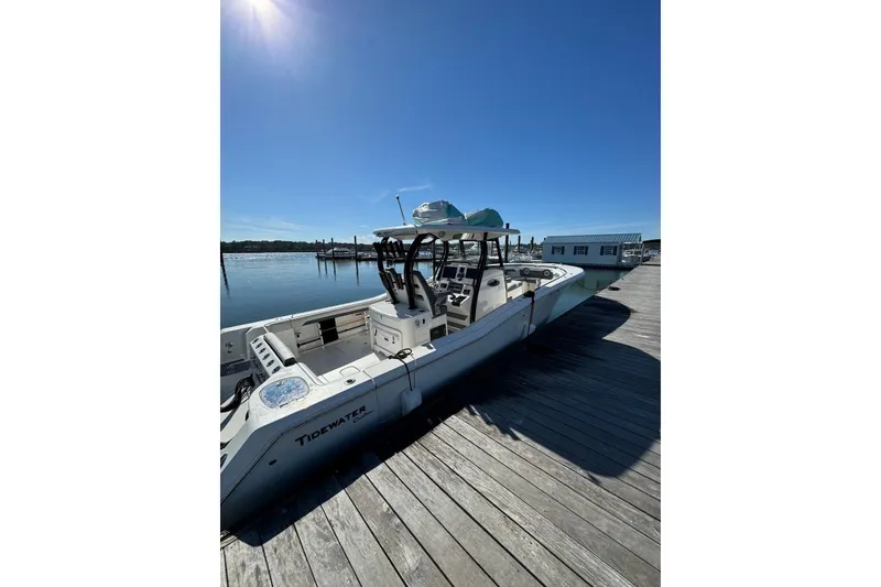 Slide: The Image of 2020 Tidewater 320 CC Adventure boat docked under clear blue sky. - 5