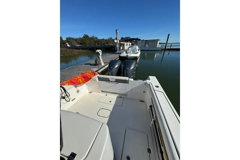 Slide: The Image of 2020 Tidewater 320 CC Adventure boat docked with dual engines. - 6