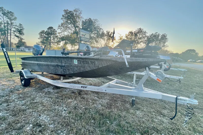 The Image of 2024 Xpress H18DB boat on trailer at sunset, featuring Garmin equipment. - 0
