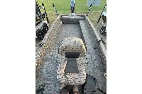 Slide: The Image of 2024 Xpress H18DB boat interior with camouflage seating and spacious deck. - 5