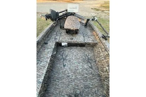 Slide: The Image of 2024 Xpress H18DB boat interior with camouflage design and fishing equipment. - 7