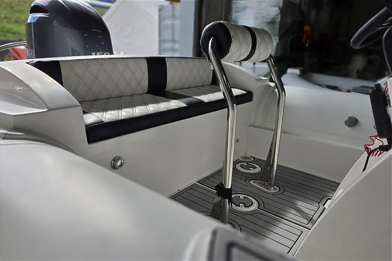 Slide: The Image of 2021 Novurania Como 18 boat interior with cushioned seating and stainless steel accents. - 10