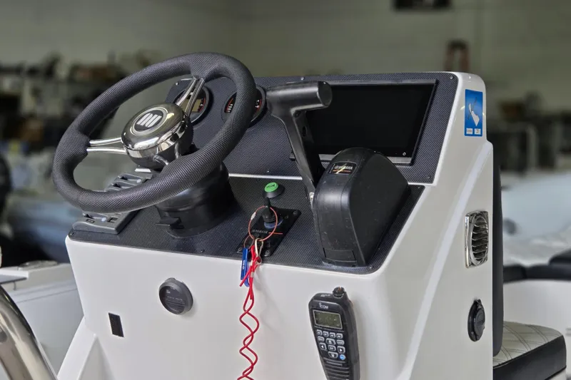 Slide: The Image of Steering console of 2021 Novurania Como 18 boat with modern controls and instruments. - 6