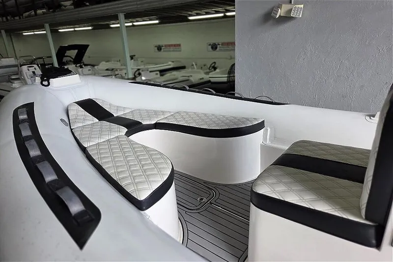 Slide: The Image of 2021 Novurania Como 18 boat interior with quilted seating in a showroom. - 9