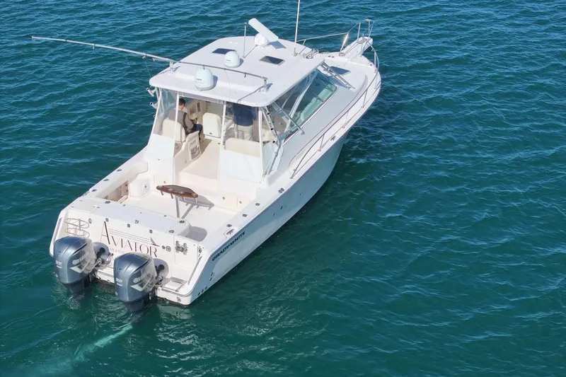 Slide: The Image of 2008 Grady-White Express 360 boat on clear blue water, featuring twin outboard engines. - 10