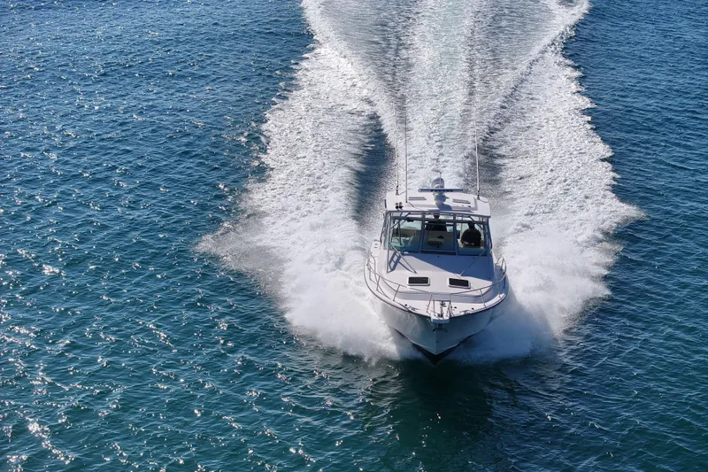 Slide: The Image of 2008 Grady-White Express 360 boat cruising on clear blue water. - 12