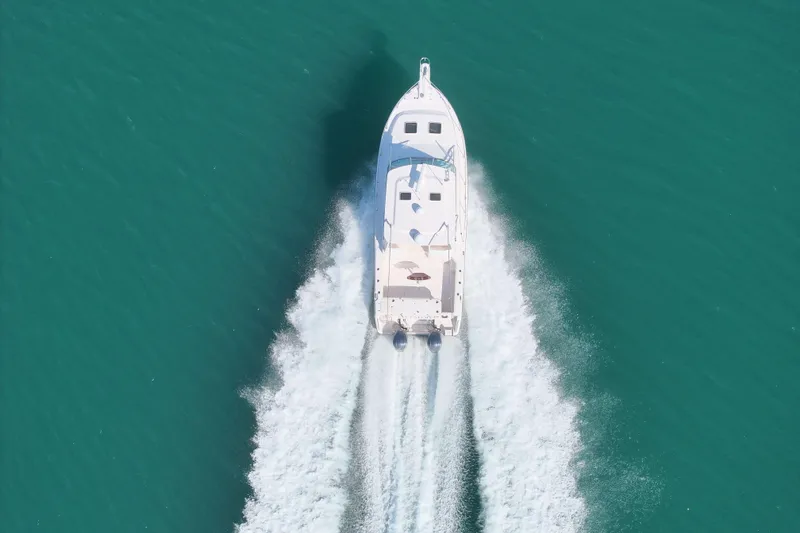 Slide: The Image of Aerial view of 2008 Grady-White Express 360 boat cruising on turquoise water. - 16