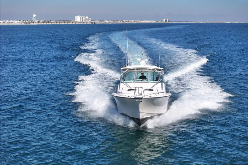 Slide: The Image of 2008 Grady-White Express 360 cruising on open blue water, leaving a wake behind. - 18