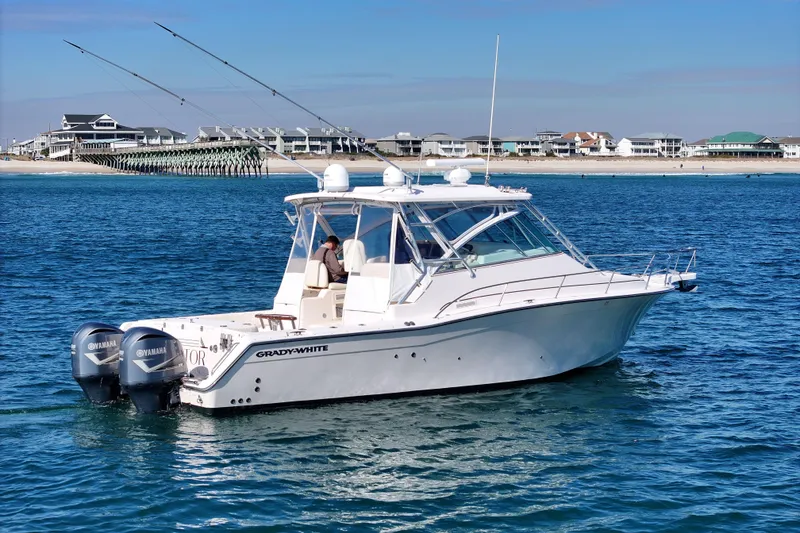 Slide: The Image of 2008 Grady-White Express 360 boat on water, with coastal houses in background. - 2