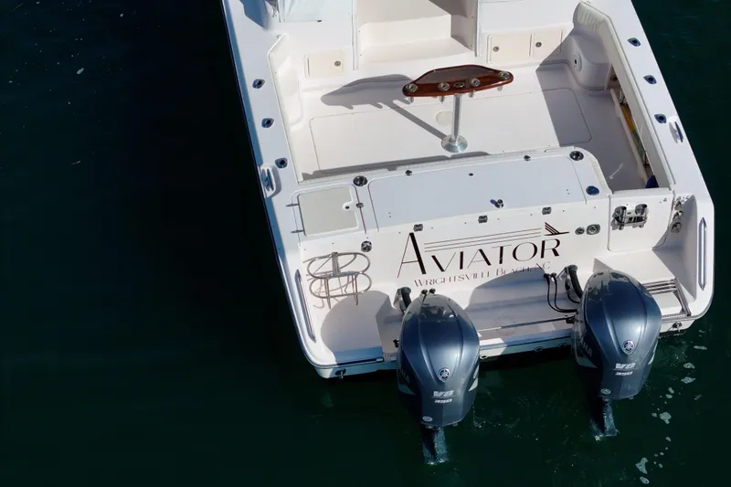 Slide: The Image of 2008 Grady-White Express 360 boat with twin engines, named "Aviator," docked in water. - 22