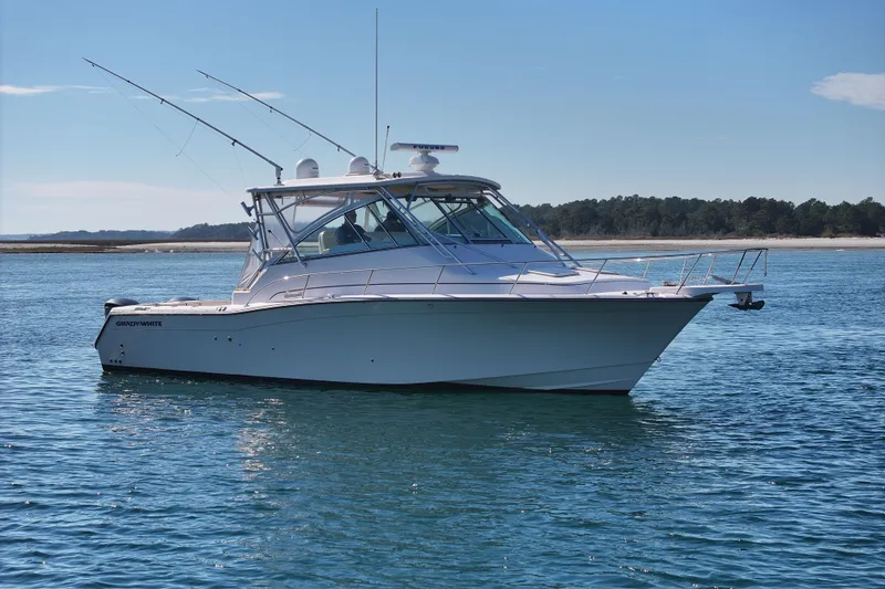Slide: The Image of 2008 Grady-White Express 360 boat on calm water, clear sky background. - 3