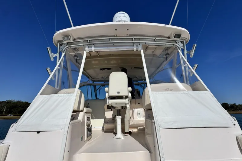 Slide: The Image of 2008 Grady-White Express 360 boat with clear enclosure and seating, under a blue sky. - 35