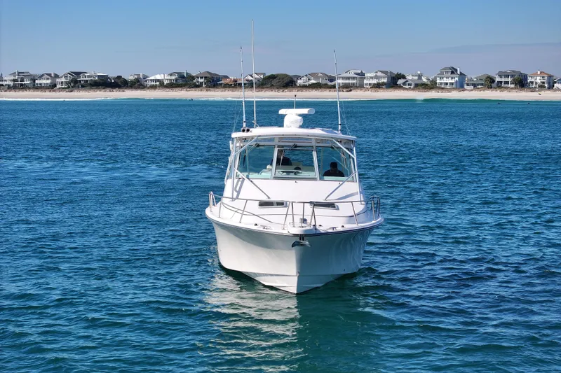 Slide: The Image of 2008 Grady-White Express 360 boat on blue ocean near coastal homes. - 4
