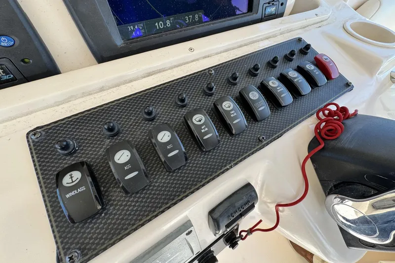 Slide: The Image of Control panel of a 2008 Grady-White Express 360 boat with various switches and gauges. - 47