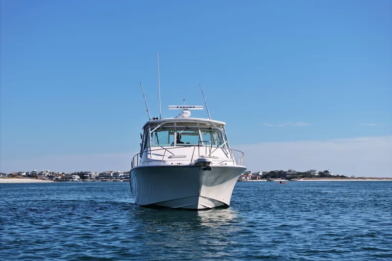 Slide: The Image of 2008 Grady-White Express 360 boat on calm water with coastal background. - 5