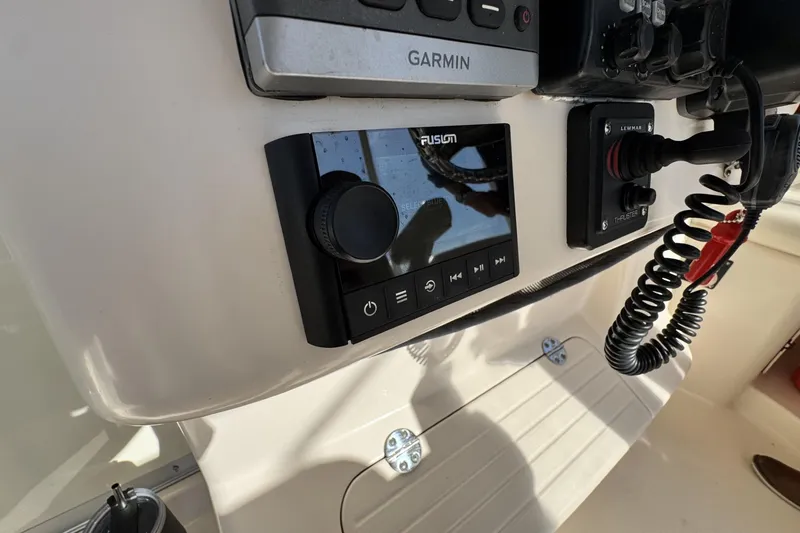 Slide: The Image of Control panel of a 2008 Grady-White Express 360 boat with Garmin and Fusion systems. - 50