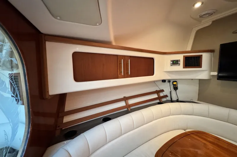 Slide: The Image of 2008 Grady-White Express 360 cabin interior with seating, wood accents, and storage. - 53